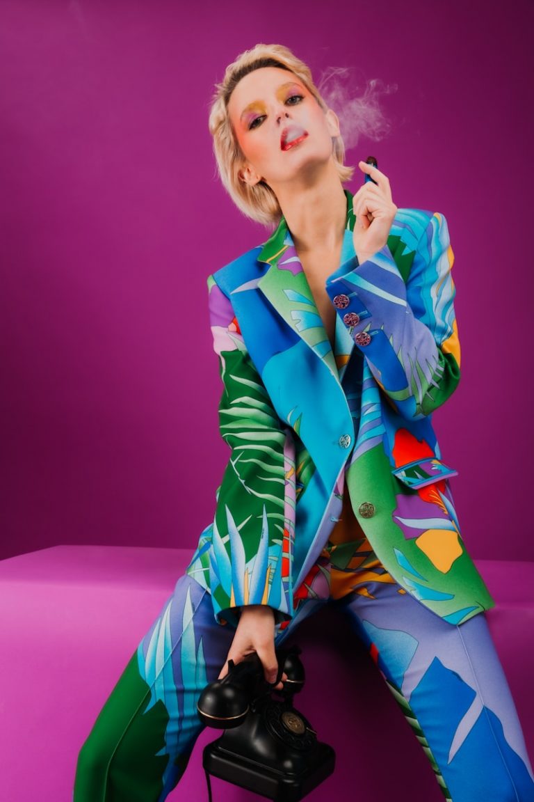 woman in blue blazer and purple skirt sitting on purple chair